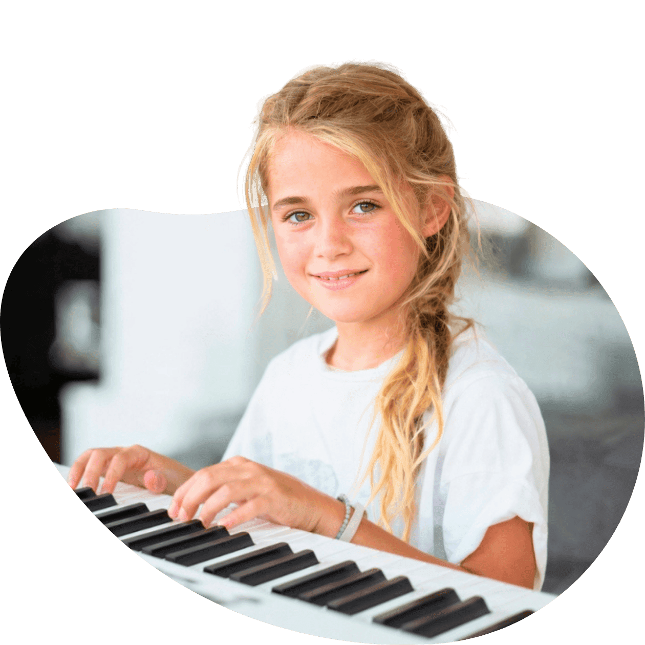 Child smiling while playing piano at home